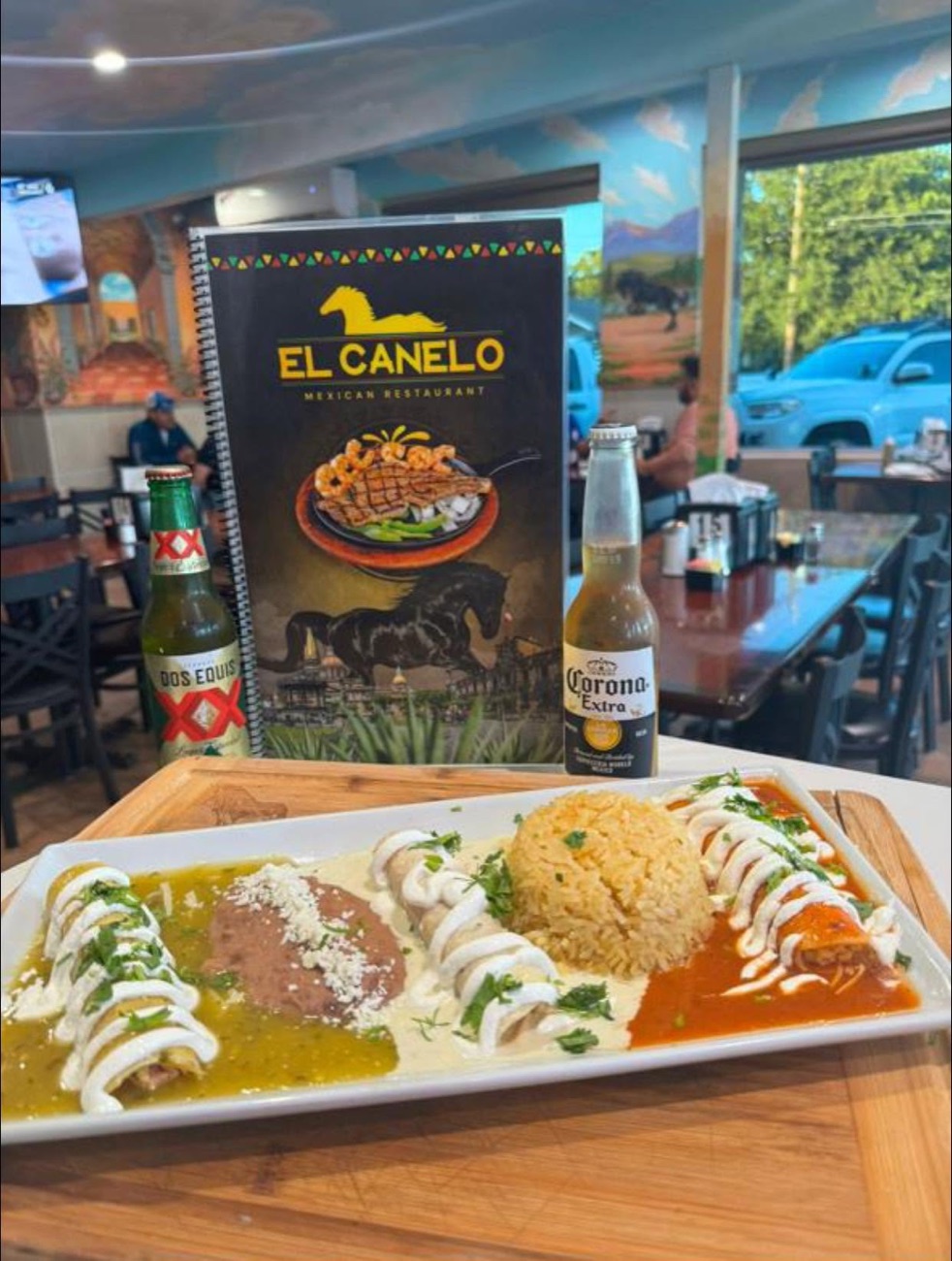 Enchiladas tricolores — green, cream, and red sauce with rice and beans