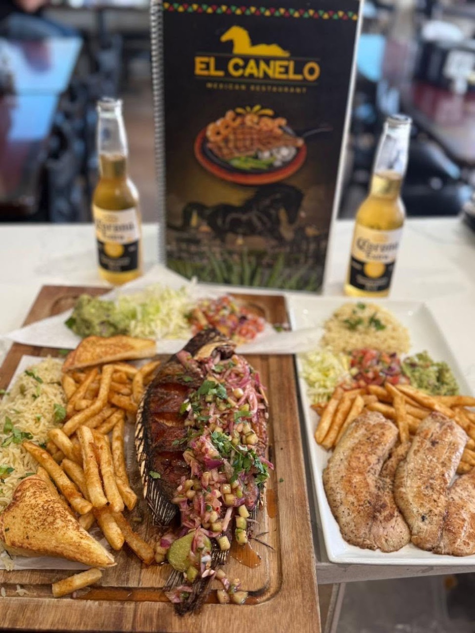 Whole grilled fish and tilapia with fries, rice, and guacamole