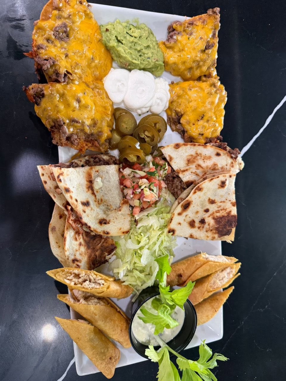 Appetizer platter — nachos, quesadillas, and taquitos dorados