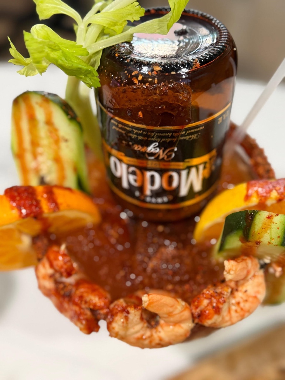 Michelada Modelo Negra — dramatic close-up with shrimp and citrus