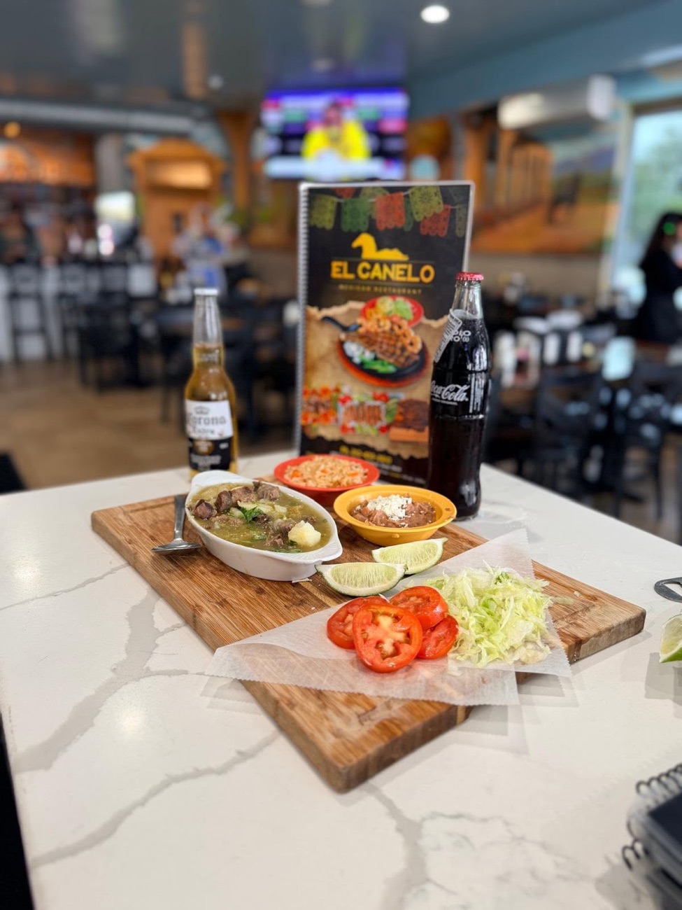 Caldo de res — beef soup with sides on a wooden board