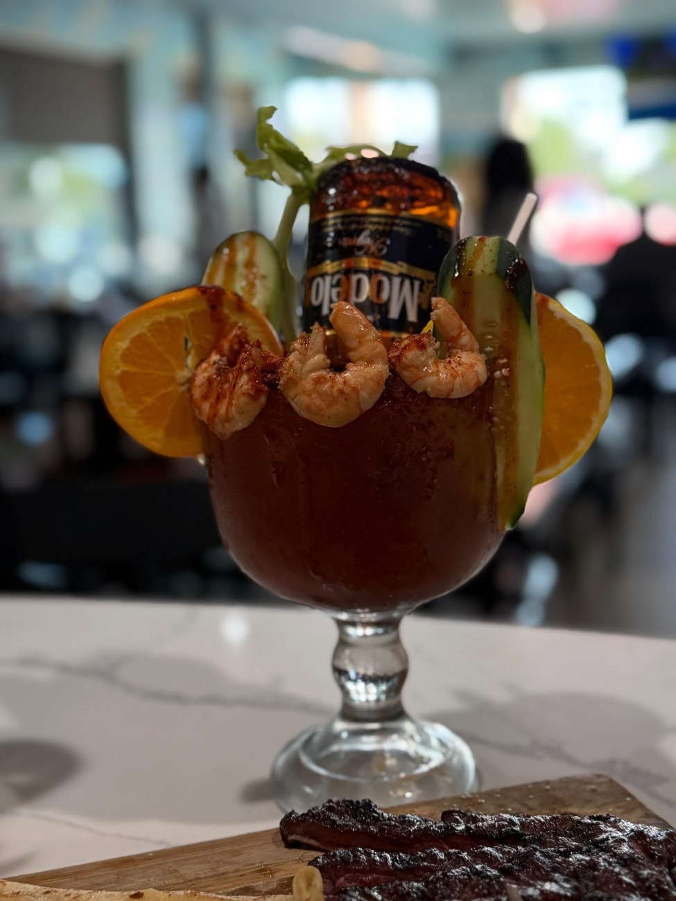 Michelada El Canelo — signature shrimp-rimmed beer cocktail close-up